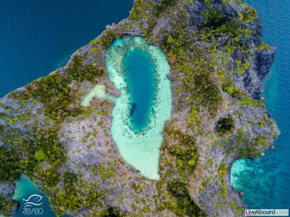Aerial drone view of a beautiful coral lagoon inside a remote tr
